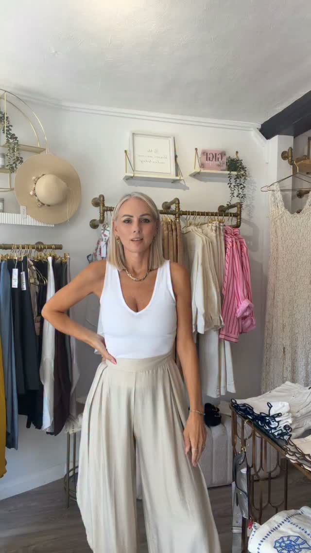 Cream wide-leg summer trousers worn in the boutique